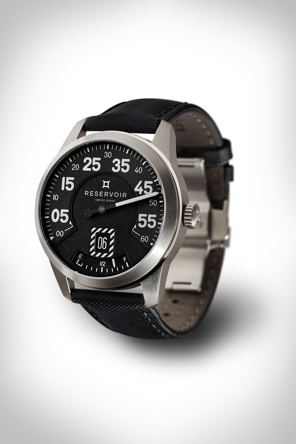 Wristwatch with stainless steel case, black dial, white numerals, and black textured strap.