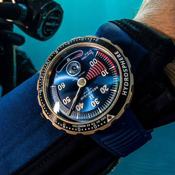 Diver's wristwatch underwater, blue face, white and red markings, HYDROSPHERE RESERVOIR, blue strap.
