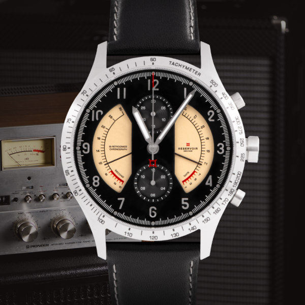 Wristwatch with black leather band, silver case, three sub-dials, tachymeter, vintage audio receiver.