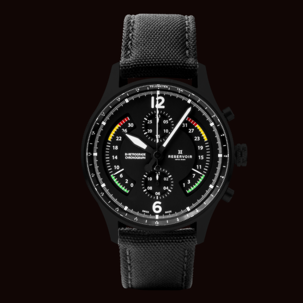 Black chronograph wristwatch with fabric strap, three subdials, white numerals, and colorful markings.