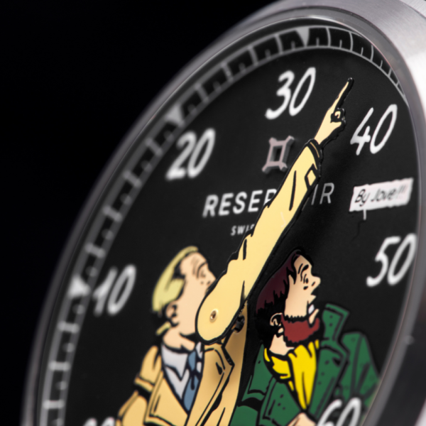 Close-up of a watch face with comic characters, numerals 10 to 50, and text "RESERVOIR" and "SWISS".