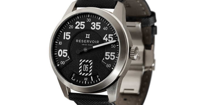 Men's wristwatch with metallic case, black dial, Arabic numerals, black leather strap, date display.