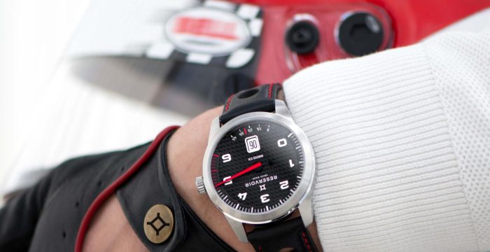 Light grey GT car with dark black and dark magenta speedometer racing.