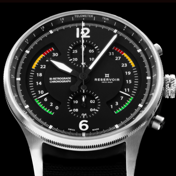 Black dial watch with bi-retrograde chronograph, sub-dials, telemeter scale, and Swiss Made label.