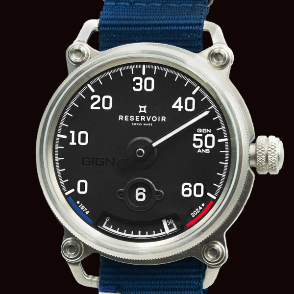 Wristwatch with black dial, white numerals, stainless case, GIGN marking, blue strap.