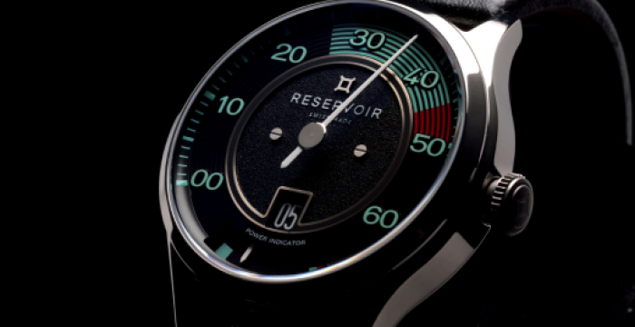 Wristwatch with black dial, mint numerals in tens, power indicator, metallic bezel, and black strap.