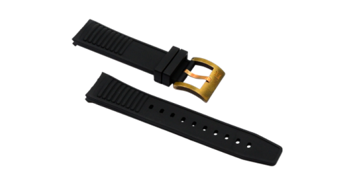 Black rubber watch strap with gold buckle, ridged ends, and multiple adjustment holes for sizing.