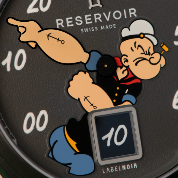 Wristwatch with a cartoon sailor flexing arm, labeled "RESERVOIR", "SWISS MADE", and "LABELNOIR".