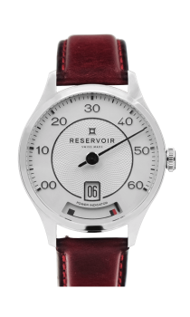 Luxury wristwatch with silver face, black hand, date, power indicator, red leather strap.