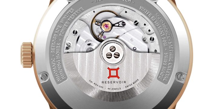 Bronze mechanical wristwatch back with exposed movement, sapphire crystal, and "RESERVOIR" branding.