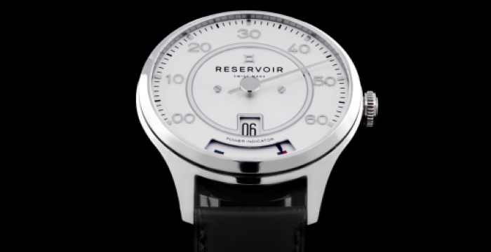 Wristwatch with a silver bezel, white dial, retrograde minute hand, black leather strap, "Reservoir" brand