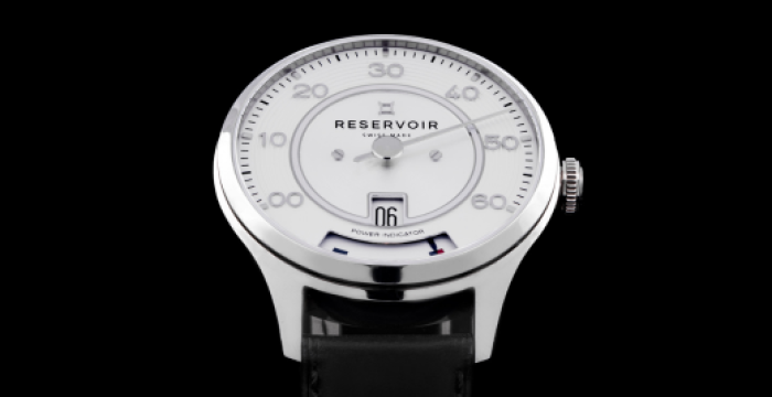 Silver wristwatch with white dial, minimalist design, black leather band, "RESERVOIR" branding.